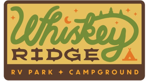 A retro-style sign logo for Whiskey Ridge RV Park & Campground features stylized green and orange text, small stars, trees, a crescent moon, and a tent graphic set against a brown and yellow background.